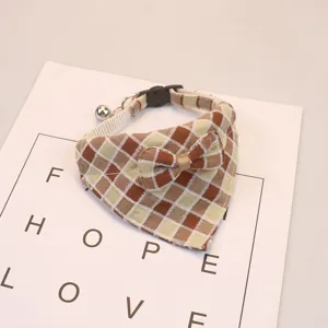 Plaid pet bib collar with cute bow tie and bell, adjustable dog cat bandana detail.