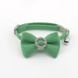 Green pet collar detail, featuring a cute bow, sparkling rhinestone ring, and a crisp bell.