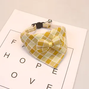 Cute yellow plaid pet bib with bow and bell, soft polyester cotton cat dog collar for daily wear.