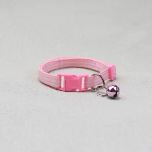 Pink plaid pet collar detail featuring a quick-release buckle and a cute jingle bell.