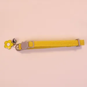 Corduroy cat collar detail featuring cute flower pendant, bell and adjustable buckle.