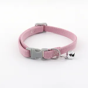 Pink fabric pet collar with grey plastic buckle and metal bell for cats and small dogs.