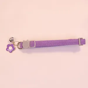 Purple corduroy pet collar with cute bell, flower pendant, and adjustable safety buckle.