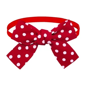 Detail view of the red and white polka dot pet bow tie, showing the cute fabric and ribbon.