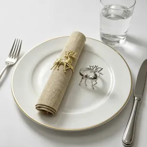 Elegant metal reindeer napkin rings in gold and silver, perfect for Christmas table decor.