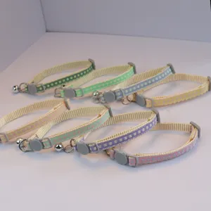 Cute colorful checkered pet collar detail, soft fabric kitten neck strap with bell and safety buckle.