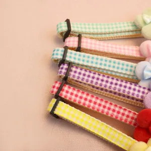 Cute plaid flower pet collar with plush bow, colorful neck strap for cats and dogs, detail view.