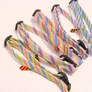 Detailed shot of colorful striped pet collars with cute tie charms, ideal for cats and small dogs.