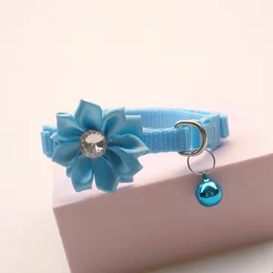 Blue pet collar detail featuring a sparkling rhinestone flower and cute bell for cats and dogs.