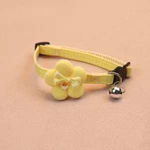 Cute yellow plaid pet collar with plush flower bow and bell detail for cats and dogs.