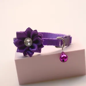 Detail shot of the purple pet collar showing the satin fabric flower, rhinestone accent.