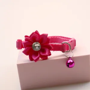 Detailed view of pink pet cat dog collar with satin flower rhinestone and a cute bell.
