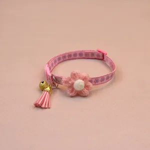 Pink floral cat collar detail view, knitted flower and bell decoration for cute pets