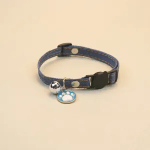 Adjustable denim pet collar featuring a bell and cute paw print pendant for cats and dogs detail