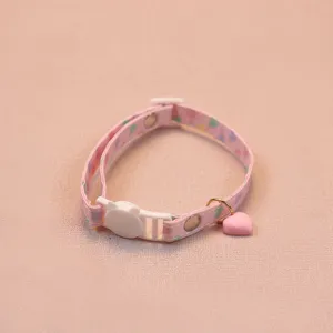 Cute pink pet collar detail view featuring a heart charm, cat buckle and adjustable strap.