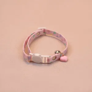 Close-up view of the cute pink cat collar featuring a heart pendant and bell detail.