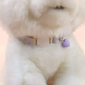 Close-up detail of cute pet cat collar with purple heart pendant and safety buckle.