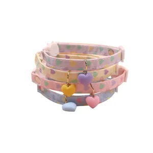 Cute pastel pet collar with heart charm and safety buckle for cats and small dogs.