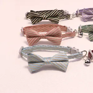 Striped pet collar with bow tie and bell, adjustable cat and dog neck accessories.