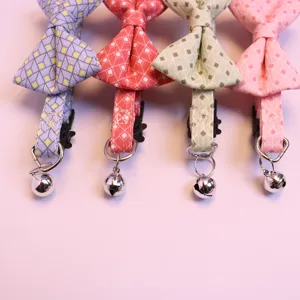 Cute pet bow tie collar detail with bell and geometric plaid pattern for cats and small dogs.