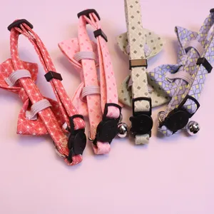 Cute plaid pet collar with bow and bell for cats and dogs, adjustable design detail.