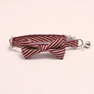 Detailed view of striped pet collar with bow tie and bell for cats and dogs, beautiful.