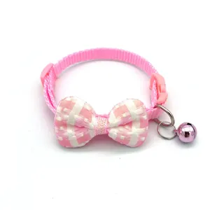 Detailed view of cute pink plaid pet collar with bowknot and bell for cats and dogs.