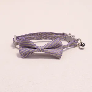 Cute striped pet cat collar with bow tie and bell, adjustable safety buckle accessory.