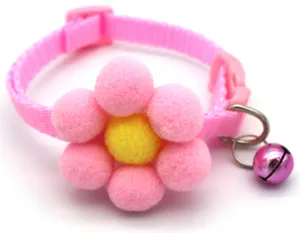 Close-up detail of cute pink pet collar with plush pom pom flower and bell for cats dogs.