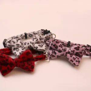 Fluffy leopard print pet collar detail, close-up of cute bowknot and bell for cats and dogs