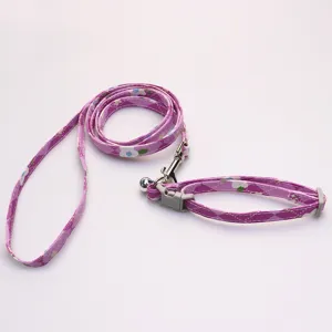 Detailed shot of purple floral pet leash and collar set, featuring secure metal hook and clasp.