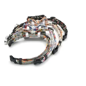 Floral cat collar with bow and bell, soft fabric pet accessory detail view showing strap.