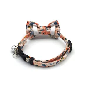 Floral cat collar with bow tie and bell, adjustable safety pet accessory for kittens and small cats.