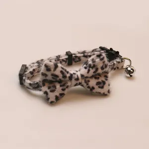 Close-up detail of the fluffy leopard print pet bow collar with a cute little metal bell.