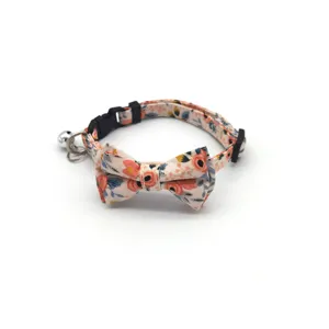 Floral pet cat collar with cute bowknot and bell, detailed view of fabric and hardware.