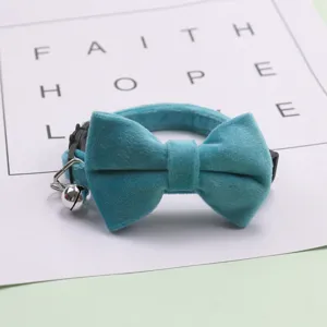 Blue velvet pet collar with bow and bell for small dogs and cats, soft and comfortable detail.