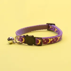 Purple cat collar detail showing metallic gold moon and star print with cute cat buckle.