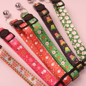 Christmas pet collar detail showing festive patterns, metal bells, and secure plastic buckle.