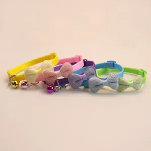 Colorful pet collar with cute bow and bell for cats and small dogs, soft fabric detail.