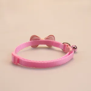 Cute pink pet collar with cute bow and metal bell for cats and small dogs detail view.