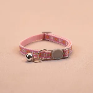 Pink floral pet collar with safety buckle and bell for cats and dogs, detailed view.