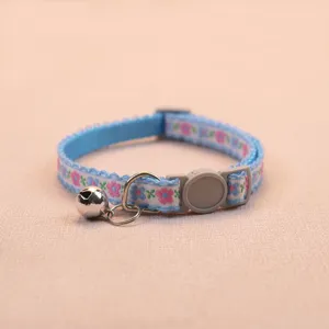 Blue floral pet collar detail, featuring safety buckle, metal D-ring and a cute bell.