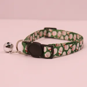 Christmas cat collar with metal bell and Santa print, safe buckle detail showcase.