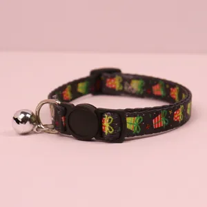 Close-up detail of the Christmas pet collar featuring a festive gift pattern, buckle and bell.