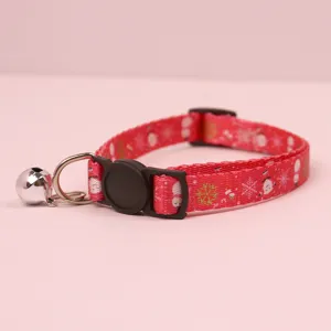 Detail view of the red Christmas pet collar featuring cute snowman prints, a bell, and a safety buckle.