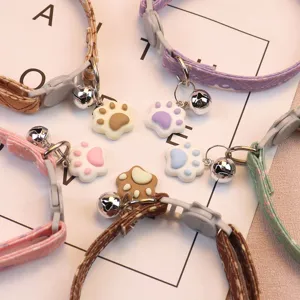 Close-up detail of adjustable pet cat collar with cute paw pendant and bell multi colors