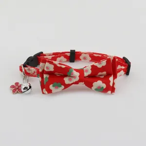 Cute red floral pet cat collar with bow tie and bell, adjustable daily neck accessory detail.