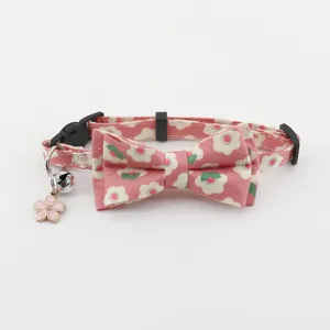Pink floral pet cat collar detail featuring a cute bowknot and a charming flower bell pendant.