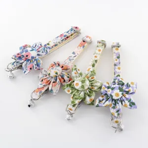 Floral pet collar with fabric daisy flower and bell, adjustable strap for cats and dogs detail.