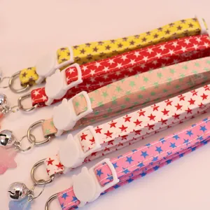 Close-up detail of cute pet collars with star patterns, cat buckles, and bells for cats dogs.